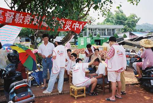 Church volunteers giving haircuts to and praying with victims of the 1999 earthquake in a tent city