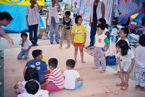 A children's programme run by volunteers from Taiwan's churches in a tent city after the 1999 earthquake.   